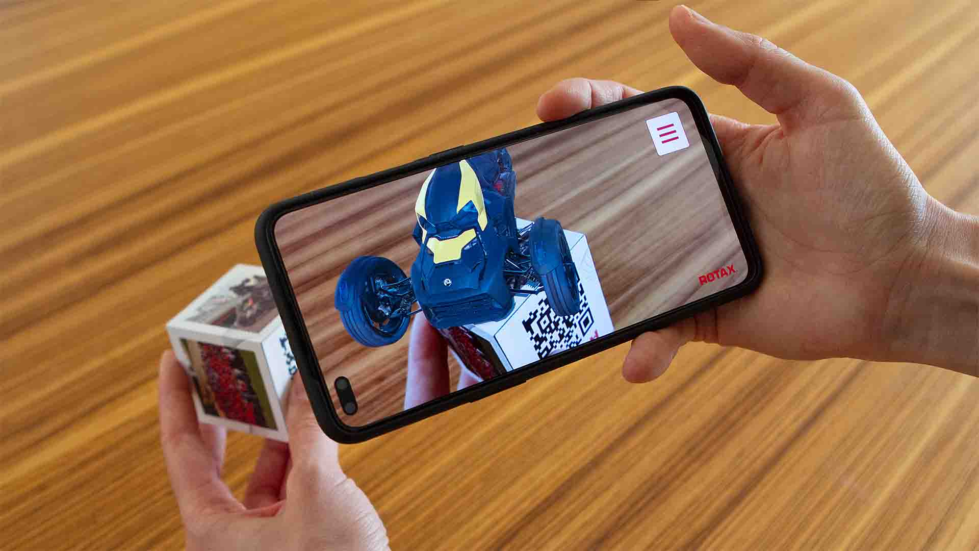 The „Rotax 100+“ Augmented Reality app brings a 6-sided real cube to life by showing digital, interactive content for each side.